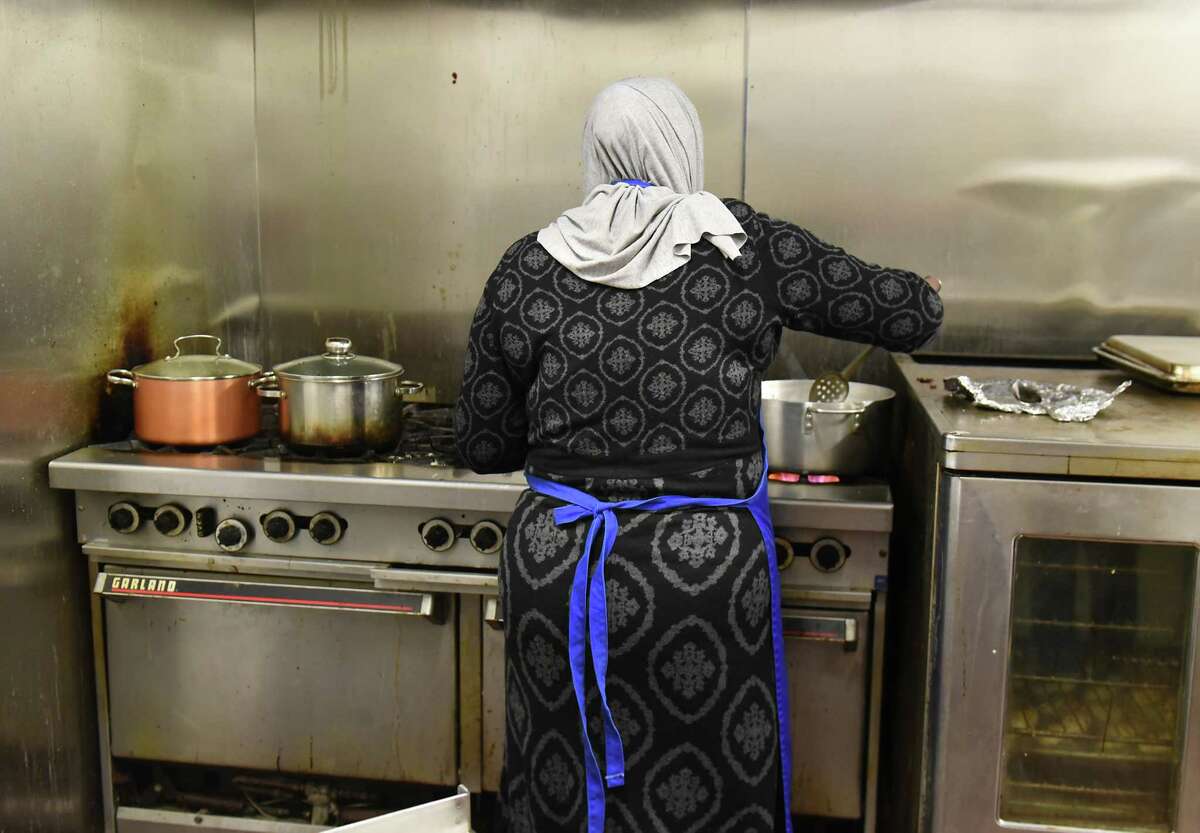 Mariam, one of several Syrian refugee women who started a catering business to support their families, makes kibbeh on the stove for their Thanksgiving order at the Sister Maureen Joyce Center on Tuesday, Nov. 20, 2018 in Albany, N.Y. (Lori Van Buren/Times Union)