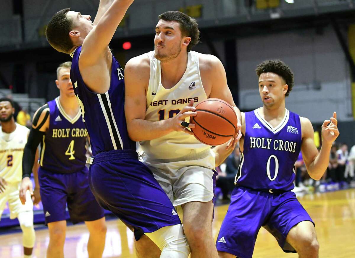University at Albany's Brent Hank is guarded by Holy Cross' Matt Faw as he drives to the hoop during a basketball game against Holy Cross at the SEFCU Arena on Tuesday, Nov. 20, 2018 in Albany, N.Y. (Lori Van Buren/Times Union)
