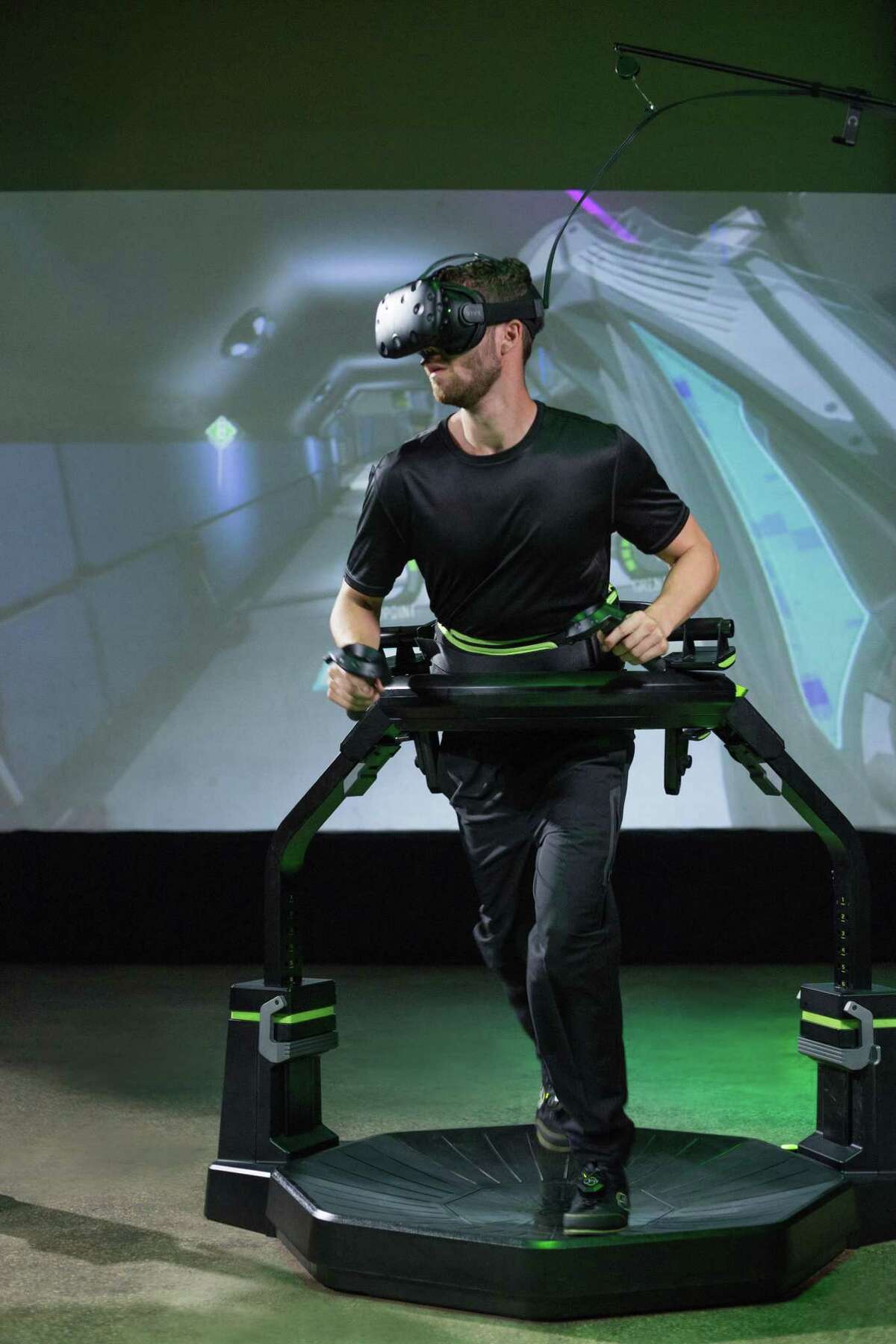 The Virtuix Omni is a treadmill-like platform that straps players inside a plastic ring positioned at waist level, allowing them to walk in any direction without risk of falling or colliding with other people. Walking or running on this device propels characters in virtual games.