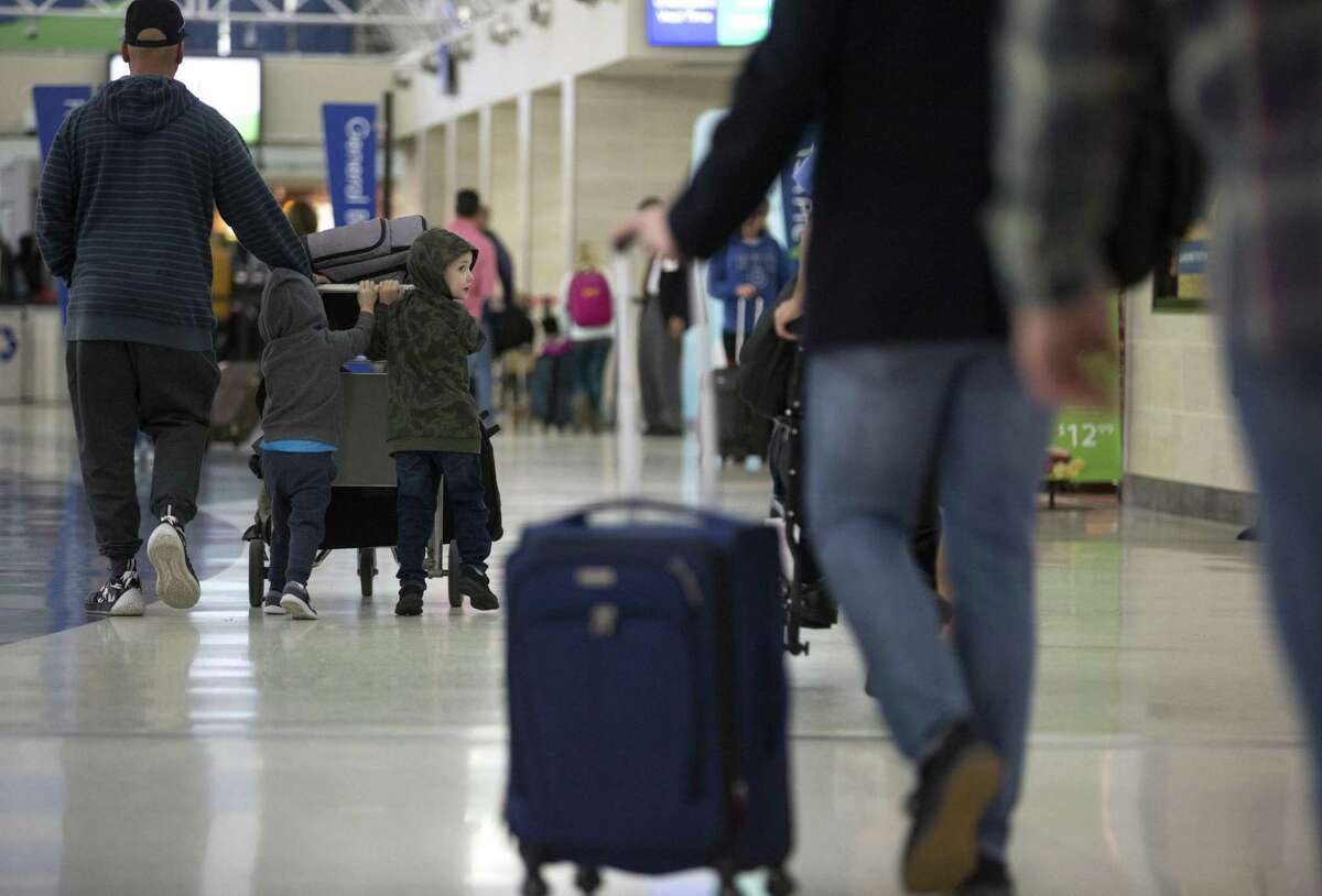Travelers make their way Wednesday, Nov. 21, 2018 through San Antonio International Airport the day before Thanksgiving. San Antonio International Airport ranked sixth among 17 midsize airports in consumer satisfaction this year, a jump from 2018 when it was in the bottom half, according to J.D. Power.