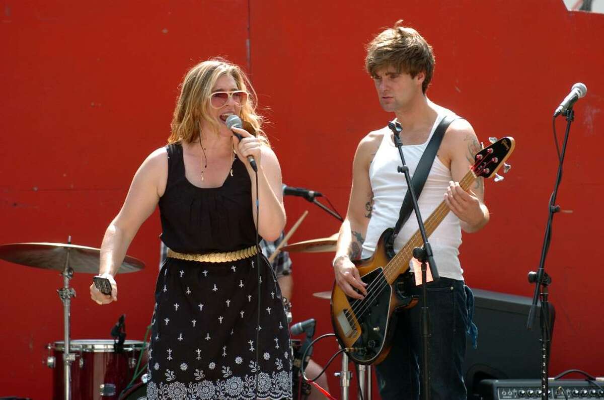 The Bridgeport based band, Saint Bernadette, performs during the Bridgeport Arts Fest at McLevy Green in downtown Bridgeport, Conn. on Saturday July 17, 2010. Pictured is lead singer Meredith DiMenna and bass player Dan Carlisle. Not pictured is guitarists Joe Novelli and Keith Saunders as well as drummer Kenny Owens.