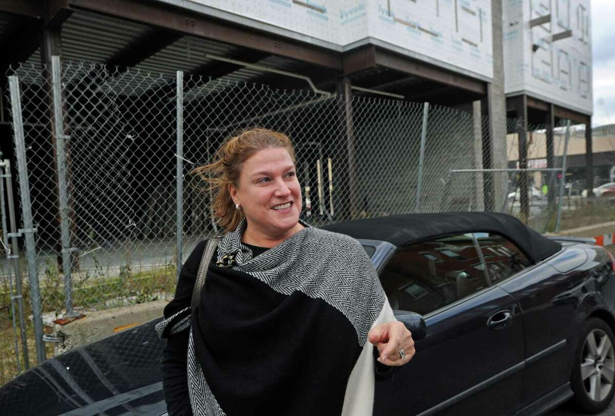 Fairfield resident Brenda Aymar parks her car next to the stalled first phase of the development Wall Street Place Wednesday, November 21, 2018, at Isaacs Street in Norwalk, Conn. The Norwalk Chief Building Official Willam Ireland says Citibank has been fined, received a failure-to-pay notification and can request a public hearing for the blight violation it received from the city in September over the condition of the stalled first phase of Wall Street Place. Ireland's summary comes in response to an email inquiry from commercial real-estate broker Jason Milligan, who has asked for the city to crack down on what he calls the Tyvek Temple.