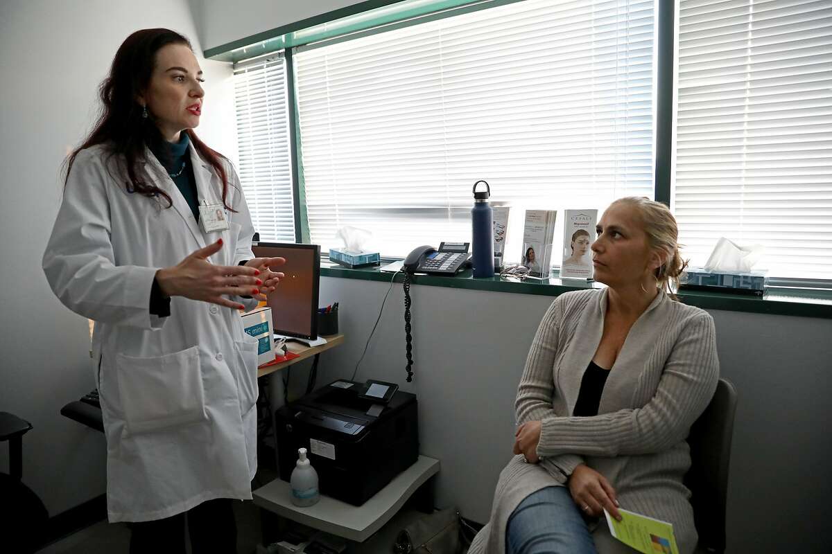 Dr. Nina Riggins, neurologist, University of California San Francisco (UCSF) Headache Center, converses with her patient Cessa Marshall during her appointment in San Francisco, Calif., on Thursday, November 8, 2018.