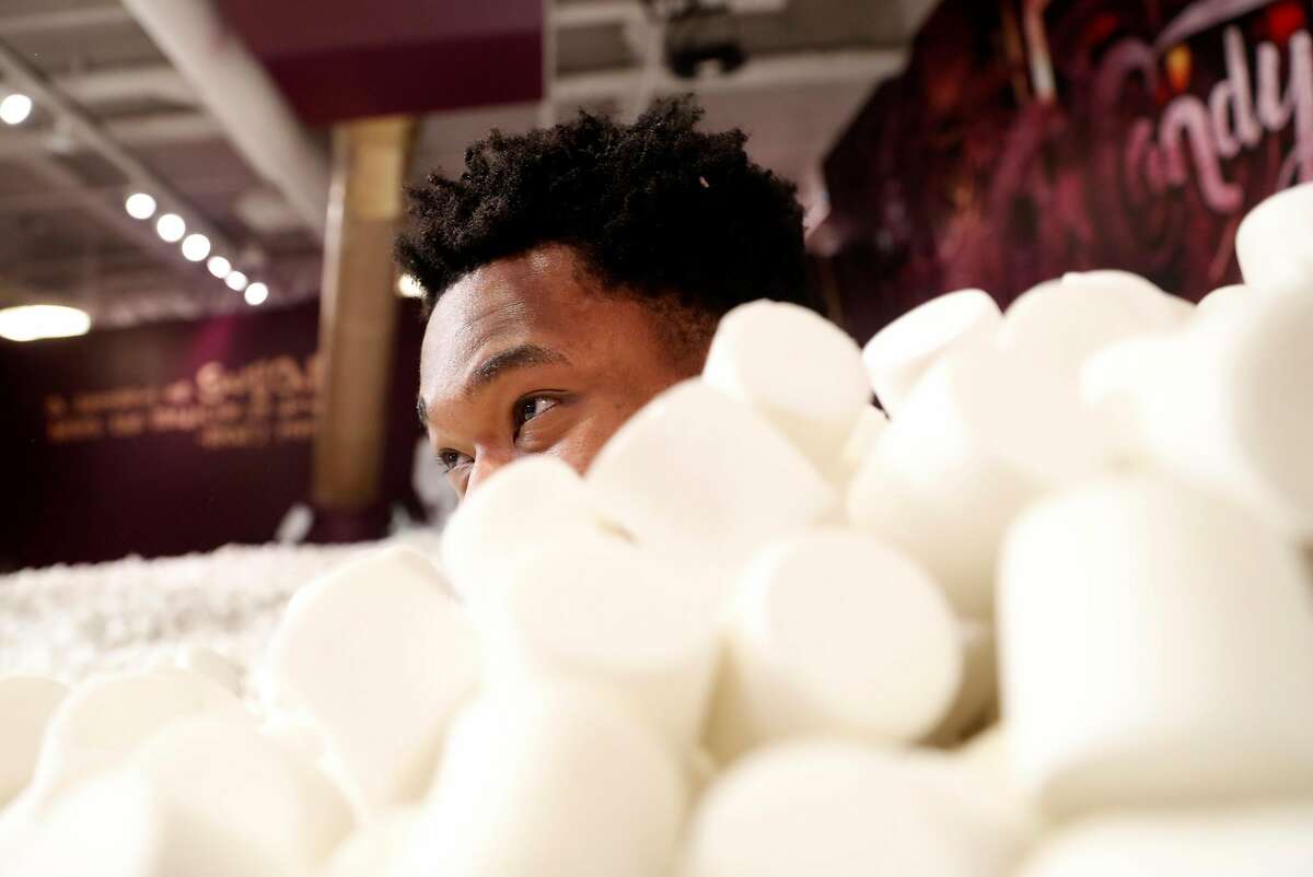 Golden State Warriors' Damian Jones in marshmallow pit at at pop-up museum, Candytopia, on National Candy Day in San Francisco, Calif.. on Sunday, November 4, 2018.