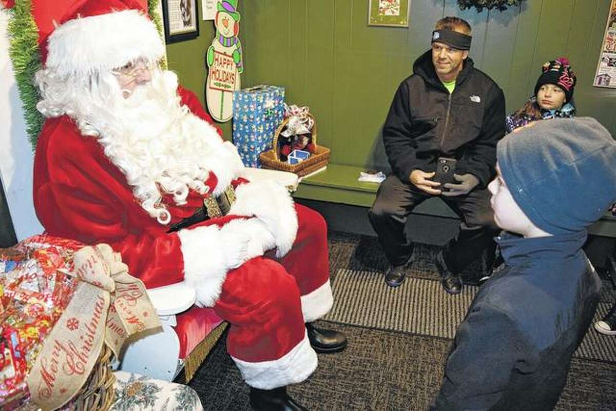 Guests visit Santa at his house during a Christmas season past on the downtown Jacksonville square. Santa will return to his house on Friday evening.