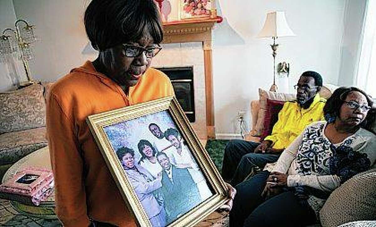 Glenda O’Neal, mother of of Dr. Tamara O’Neal, shows a photo of her family at their home in LaPorte, Indiana. Tamara was one of the three people fatally shot Monday at a Chicago hospital.