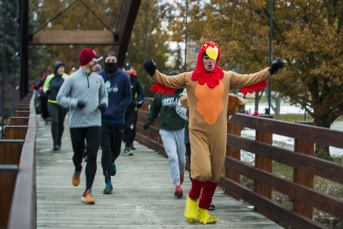 FILE - Runners and walkers cross the Tridge in Midland during the annual Turkey Trot on Thanksgiving Day, Thursday, Nov. 22, 2018.