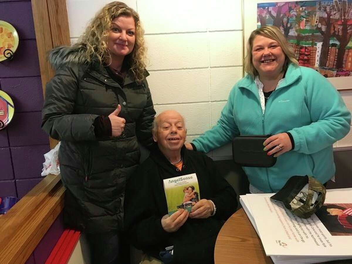 Melvin Fisher, center, the first person to use The Arc of Midland's Project Lifesaver system 10 years ago, poses with The Arc employee Kelly Lambert and Carole Weed, a direct support professional. The Arc will begin using the Angel Sense GPS system. (Photo provided)