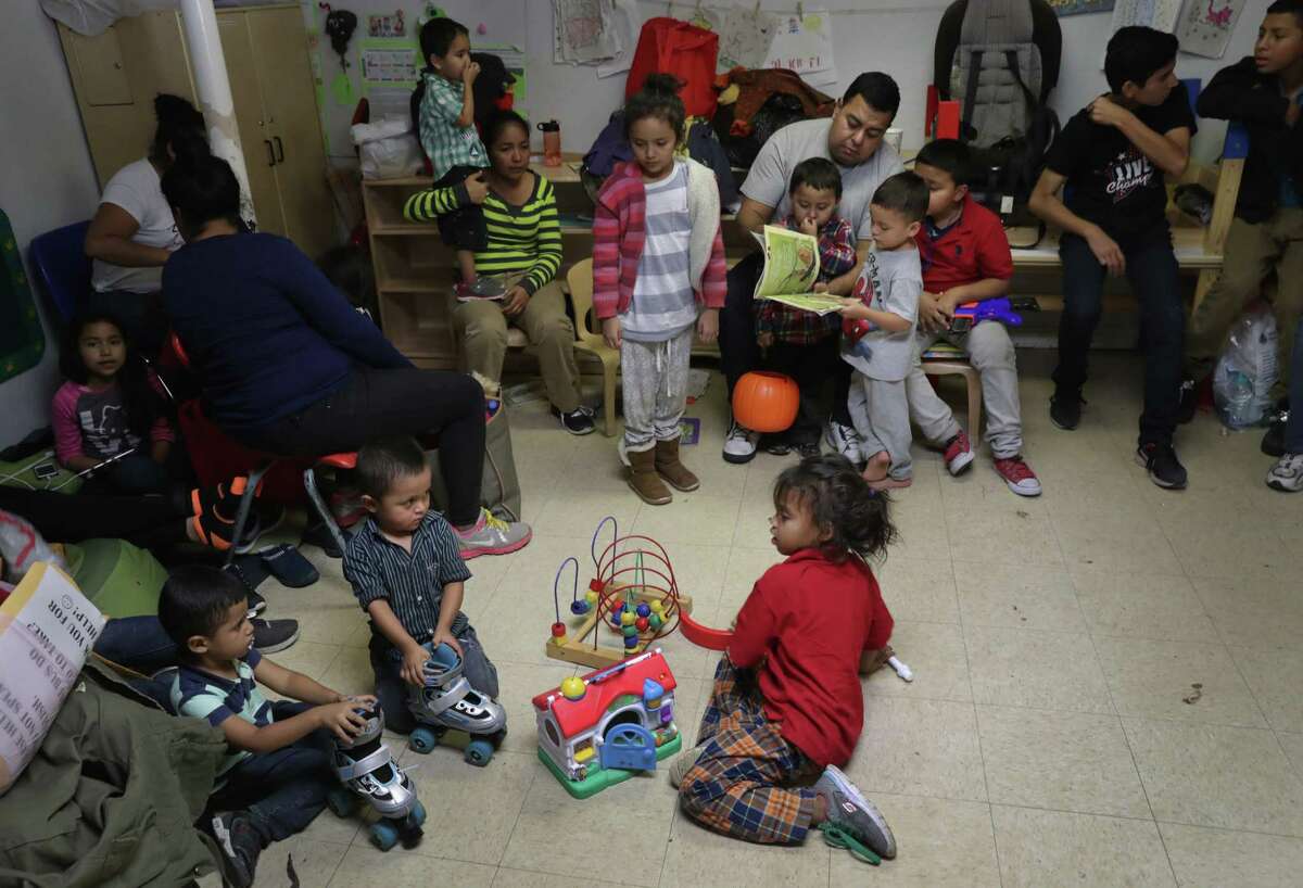 Immigrant children read and play at a Catholic Charities shelter after being released from U.S. government detention on Nov. 3 in McAllen. The number of mostly Central American children coming here alone has largely stayed steady, about 5,000 in October. The number of families coming here together however has skyrocketed to a record 23,121 last month. 