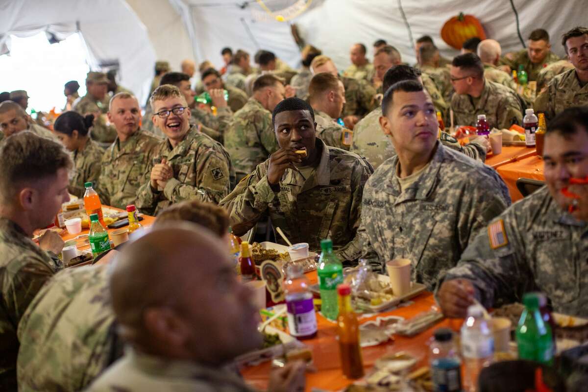 DONNA, TX - NOVEMBER 22: U.S. Army troops deployed to the U.S.-Mexico border eat a Thanksgiving meal at a base near the Donna-Rio Bravo International Bridge on November 22, 2018 in Donna, Texas. Culinary specialists prepared 34 Turkeys along with a full Thanksgiving buffet for the hundreds of troops stationed between Donna and Weslaco, Texas. (Photo by Tamir Kalifa/Getty Images)