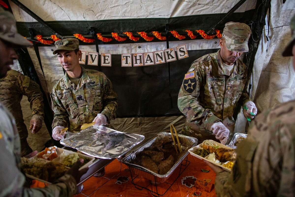 DONNA, TX - NOVEMBER 22: U.S. Army soldiers deployed to the U.S.-Mexico border serve a Thanksgiving meal to fellow troops at a base near the Donna-Rio Bravo International Bridge on November 22, 2018 in Donna, Texas. Culinary specialists prepared 34 Turkeys along with a full Thanksgiving buffet for the hundreds of troops stationed between Donna and Weslaco, Texas. (Photo by Tamir Kalifa/Getty Images)