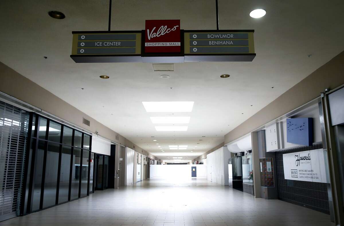 A sign guides the few customers visiting the Vallco shopping mall to businesses that remain open at the shopping center in Cupertino, Calif. on Wednesday, Feb. 14, 2018. Few tenants remain at the mall in the western Santa Clara Valley, including an AMC Theater and a couple of restaurants, but it is largely abandoned.
