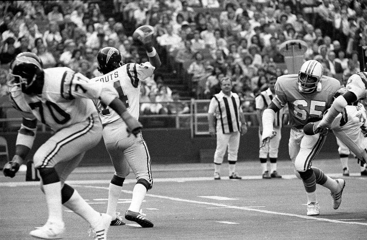 Houston Oilers Elvin Bethea (67) comes in to pressure Chargers quarterback Dan Fouts (14) in the Astrodome in 1975.