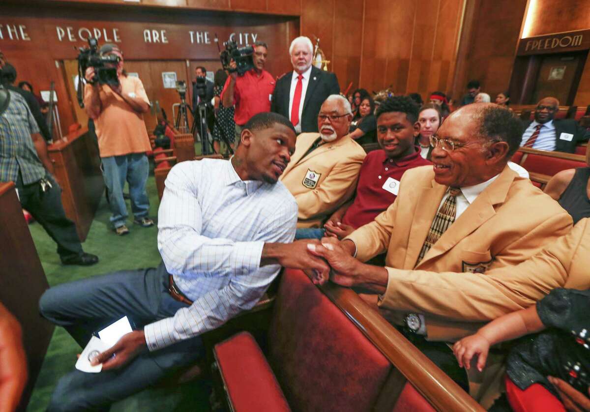 Andre Johnson, former Texans wide receiver, shakes hands with NFL Hall of Famers and chats with Elvin Bethea before he was honored with “Andre Johnson Day” by the city of Houston Tuesday, Nov. 14, 2017, in Houston.