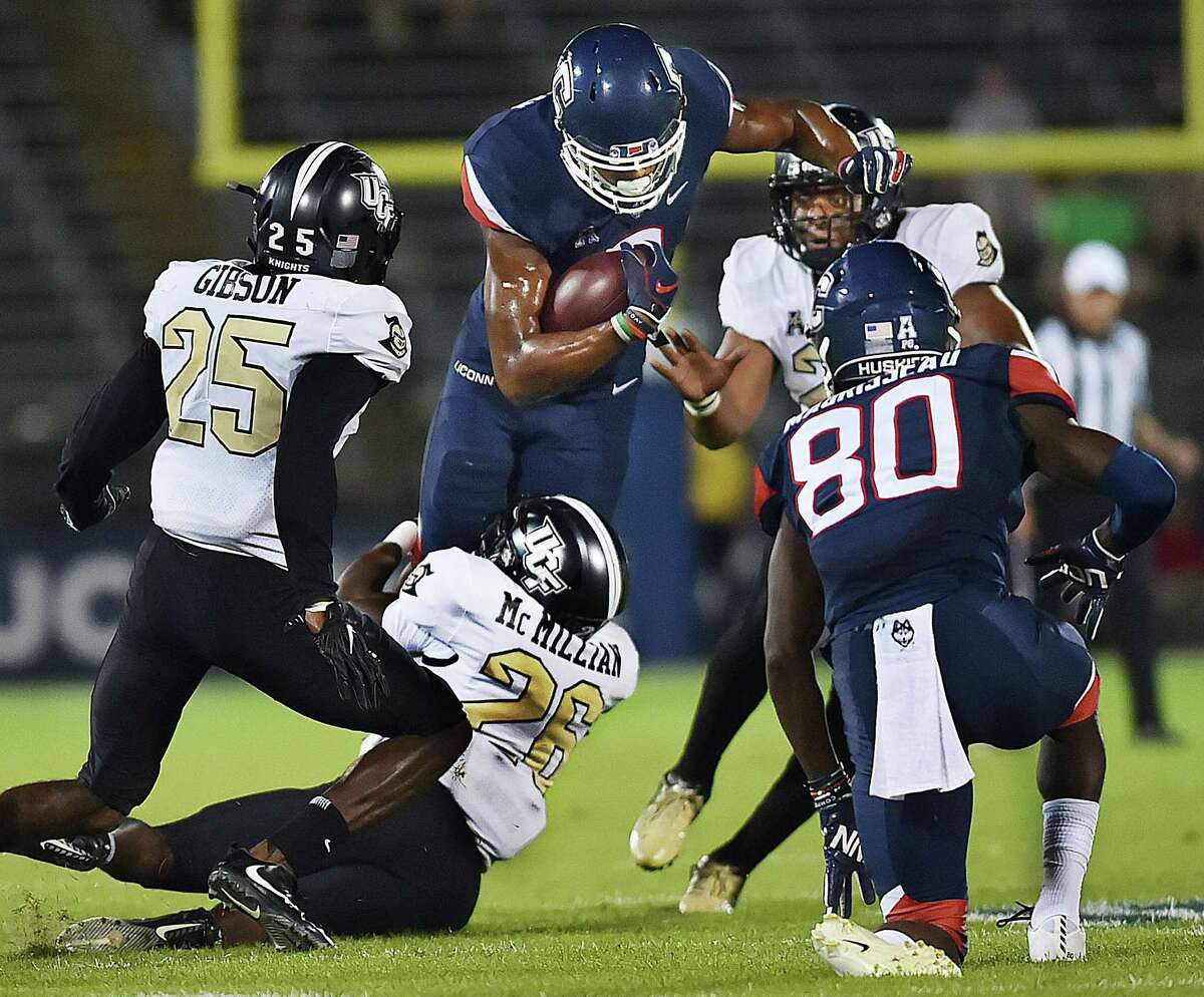 UConn tight end Aaron McLean tries to break a tackle during a game against UCF earlier this season.