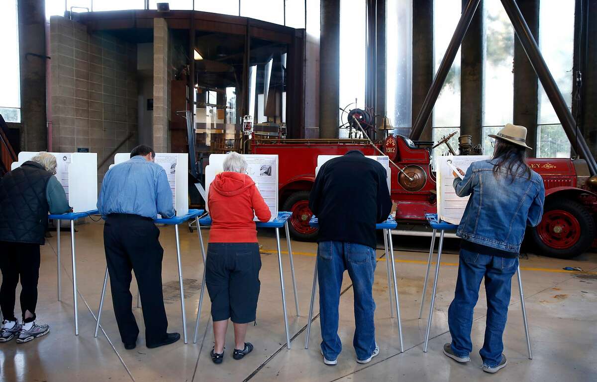 Registered voters mark their ballots at a polling place at Fire Station No. 4 in Berkeley, Calif. on Tuesday, Nov. 6, 2018.