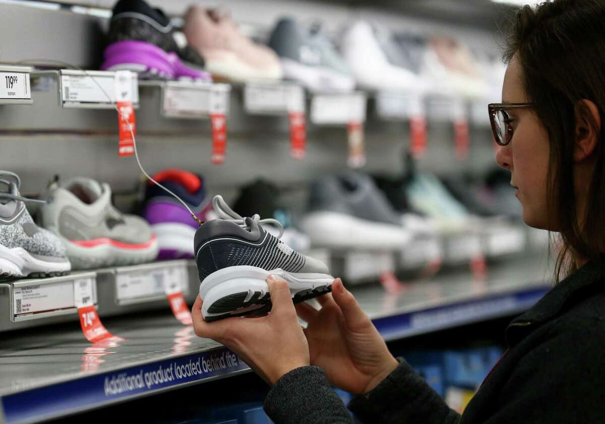 Madison Goolsby, 22, shops for shoes at the Academy Sports + Outdoors store during Black Friday Friday, Nov. 23, 2018, in Spring, Texas. Goolsby left Bryan, Texas around 1 a.m. today to arrive around 2 a.m. at the Cypress outlets.