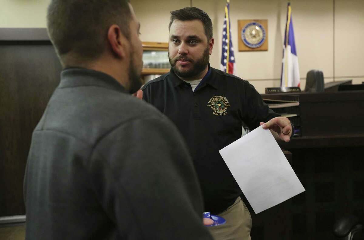 Case manager John Herman (right) talks with a military veteran in Felony Veterans Treatment Court on Thursday, Nov. 15, 2018. Two courts in Bexar County handle felony cases involving drunk driving and or drug crimes committed by military veterans called Felony Veterans Treatment Court. But instead of initially seeking punishment, the court looks to provide treatment options foremost. One of the courts is with Judge Lori I. Valenzuela in the 437th State District Court and the other is with Judge Jefferson Moore in 186th State District Court. The program is county funded and is nearing their first year of handling cases. On Thursday, Judge Valenzuela handled a typical docket with about a dozen military veterans mostly male and one female. She commended those who are nearing or completed their treatment programs and admonished those who have not progressed. At the conclusion of court, both Valenzuela and Moore invited the veterans to cookies and pastries at an informal gathering. (Kin Man Hui/San Antonio Express-News)