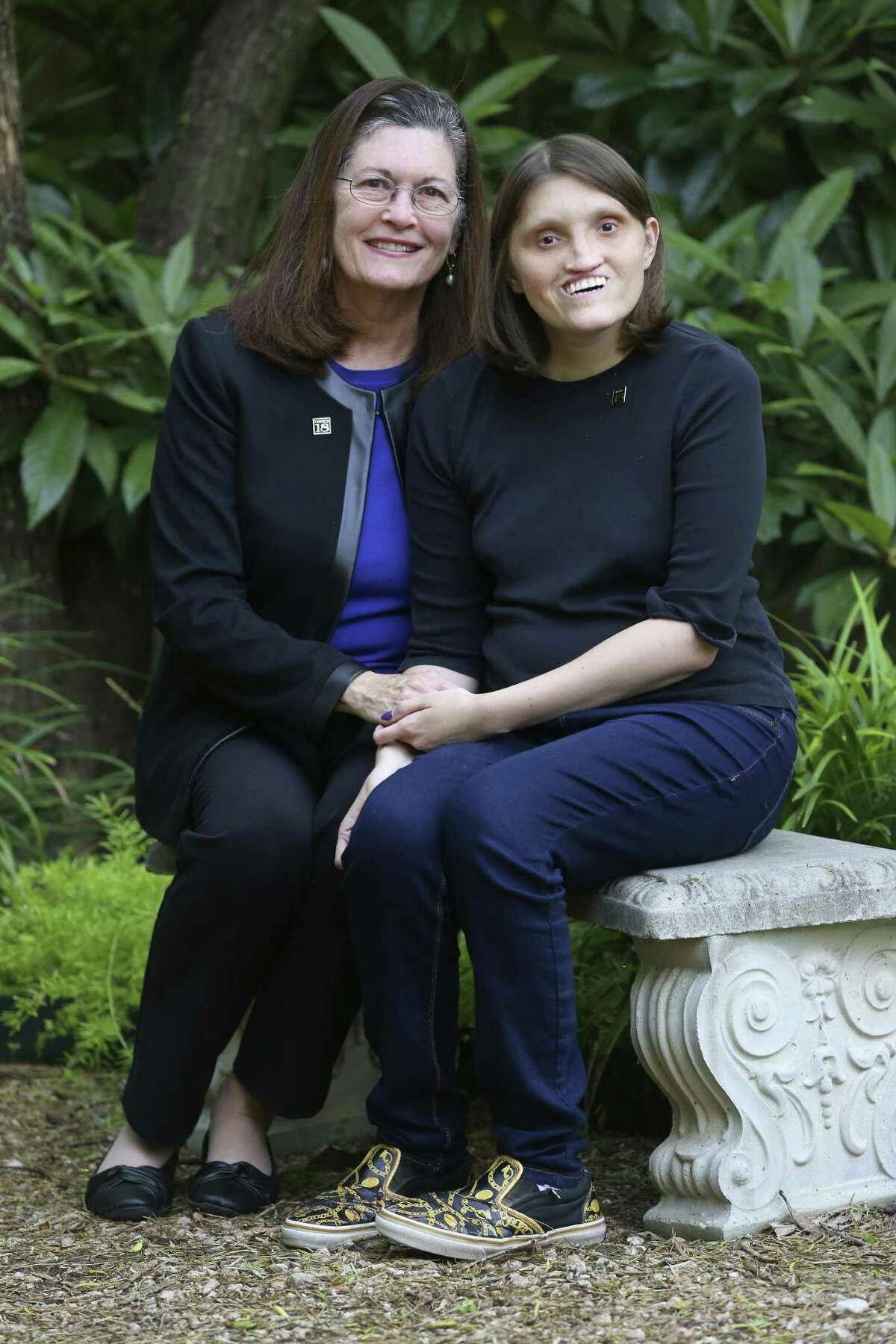 Jannine Cody, left, sits with her daughter, Elizabeth, on Nov. 6, 2018, outside their home, which is the also the office for the Chromosome 18 Registry and Research Society. Cody founded the organization, which works on behalf of people born with chromosome 18 abnormalities, after her daughter was born with the genetic condition.