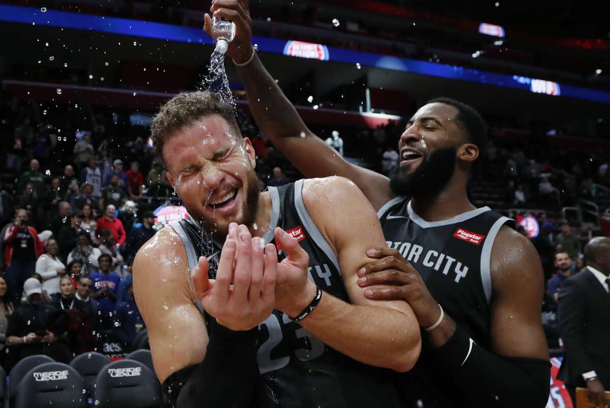 Detroit Pistons center Andre Drummond, right, pours water onto forward Blake Griffin after the Pistons defeated the Houston Rockets 116-111 in overtime in an NBA basketball game Friday, Nov. 23, 2018, in Detroit. (AP Photo/Carlos Osorio)