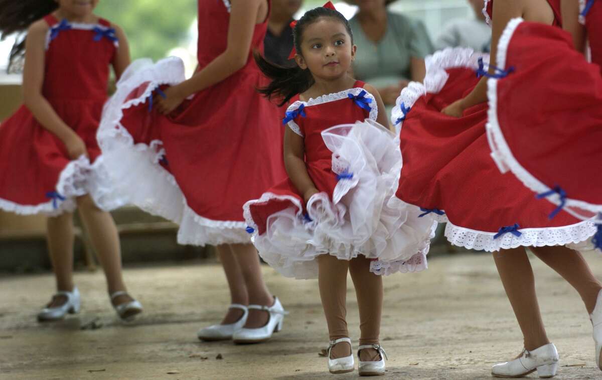 Carissa Martinez, 3, dances with Daniel's Artistic Dance Company during the Holy Family Church Spring Festival at Mateo Camargo Park on Sunday June 5, 2005. The celebration was held in conjuntion with the San Antonio Food Bank to help bring in canned goods for the needy and raise awareness of the problem of hunger in San Antonio.