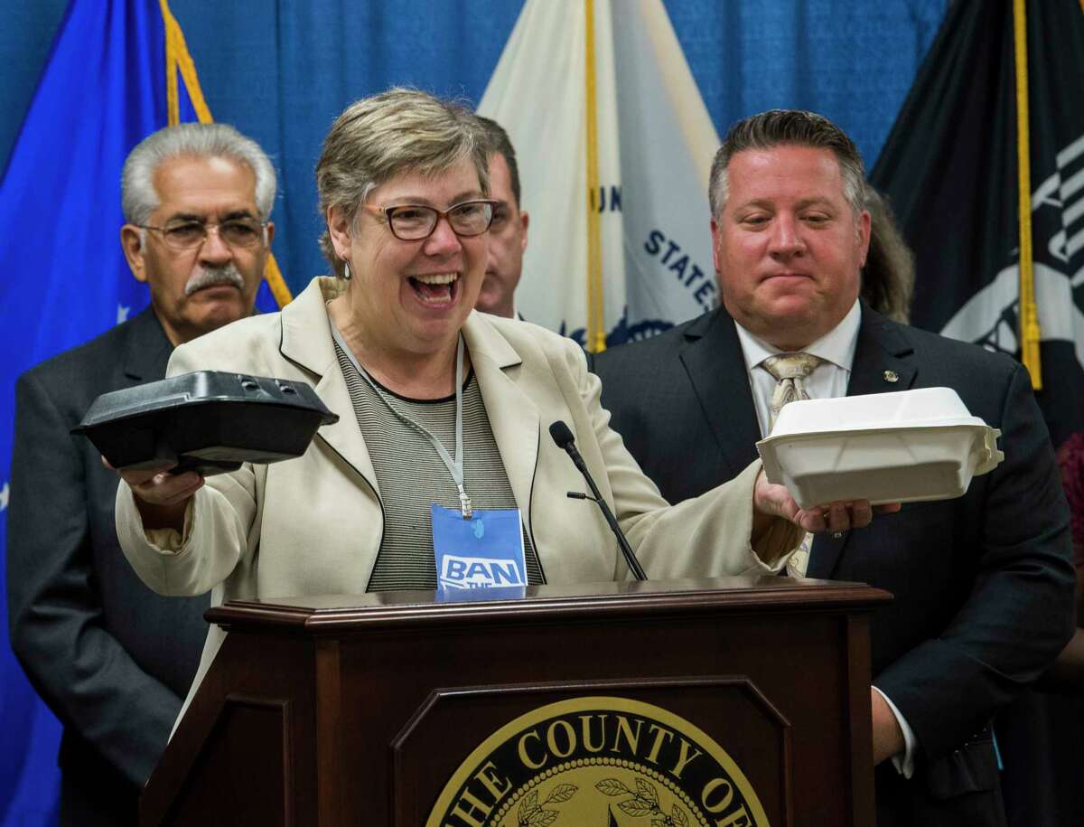 Visiting professor at Bennington College and former EPQ regional administrator Judith Enck shows the difference between the newly outlawed container, left and the environmentally safe containers which will have to be used in Albany County before County Executive Dan McCoy, right, signed it in to law with an executive order Tuesday Sept. 12, 2018 in Albany, N.Y. (Skip Dickstein/Times Union)