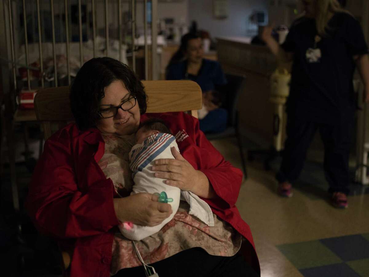 Peggy Smith, a Baptist Medical Center volunteer cuddler, holds a baby with neonatal abstinence syndrome in the neonatal intensive care unit at Baptist Medical Center on Nov. 13, 2018. Smith is a licensed vocational nurse at Brooke Army Medical Center. She volunteers once a week to cuddle babies at Baptist.