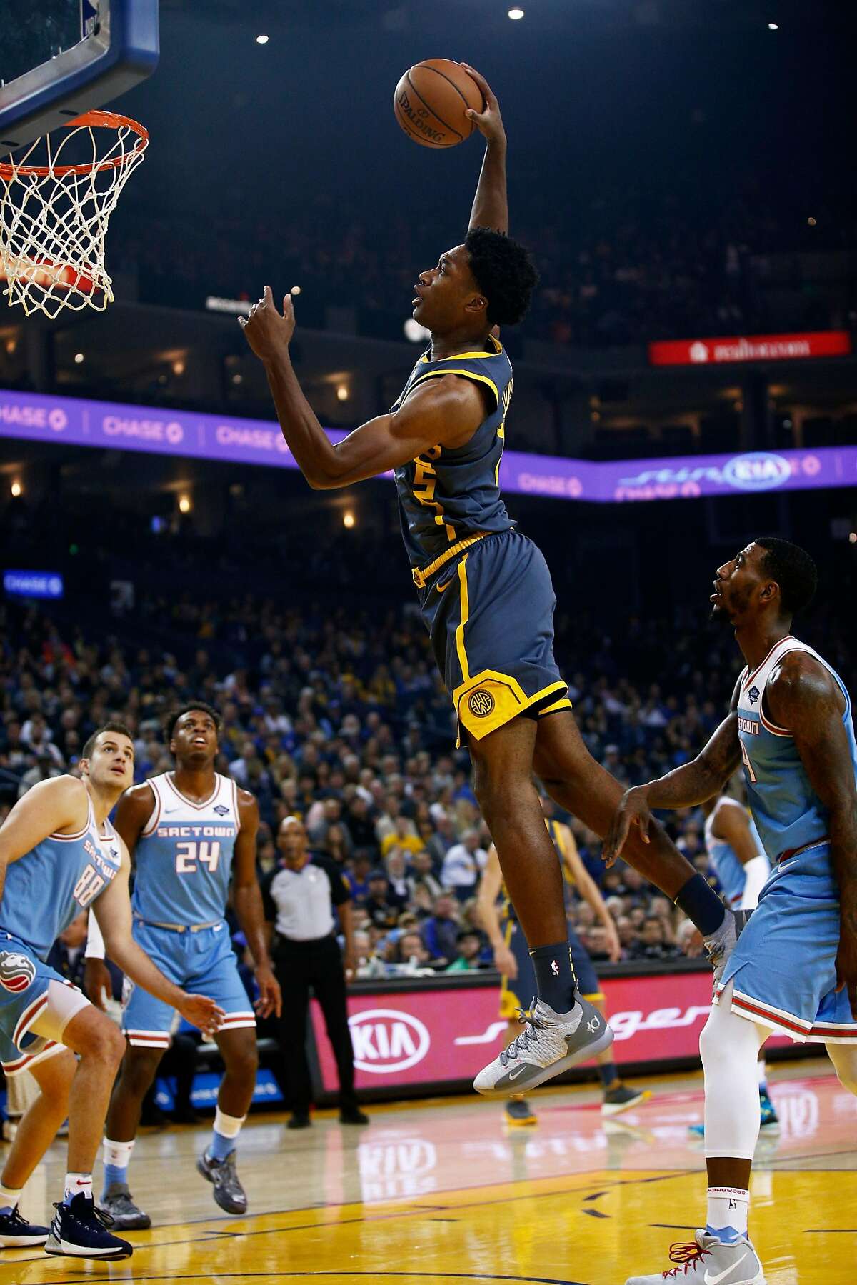 Golden State Warriors center Damian Jones (15) dunks in the first half of an NBA game at Oracle Arena on Saturday, Nov. 24, 2018, in Oakland, Calif.
