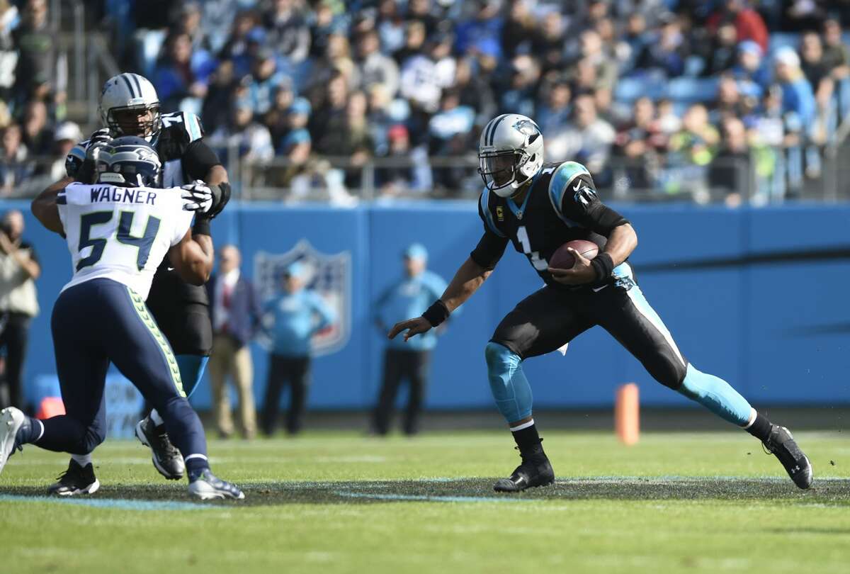 Carolina Panthers' Cam Newton (1) runs for a first down against the Seattle Seahawks during the first half of an NFL football game in Charlotte, N.C., Sunday, Nov. 25, 2018. (AP Photo/Mike McCarn)