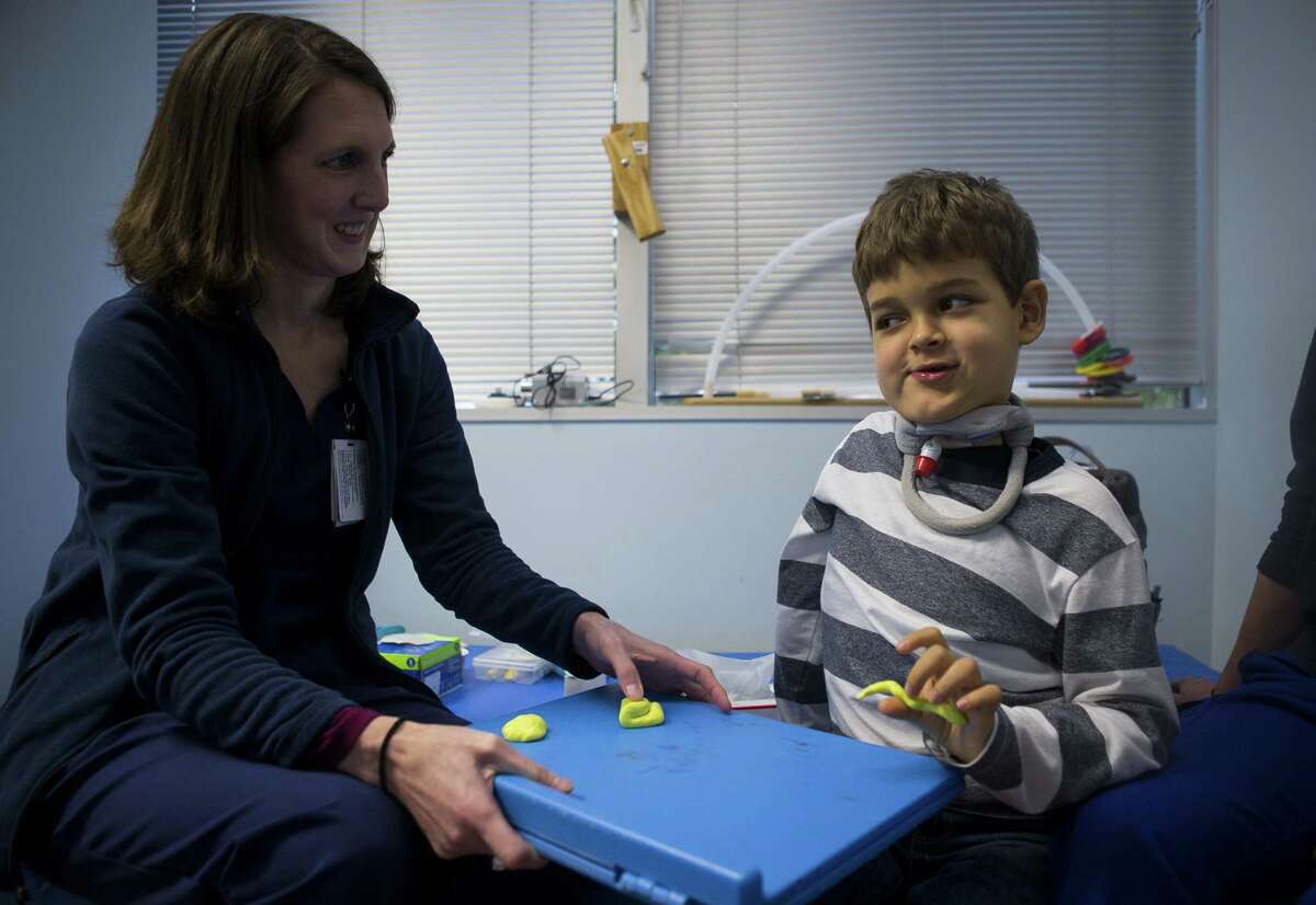 Seven-year-old Braden Scott rolls modeling clay during a speech therapy session with Jennifer Earnheart at TIRR Memorial Hermann in The Woodlands, Monday, Nov. 12, 2018. Two-years ago Braden was diagnosed with acute flaccid myelitis, or AFM. The polio-like illness has affected Braden's nervous system, causing muscle problems including having trouble swallowing, walking and writing.