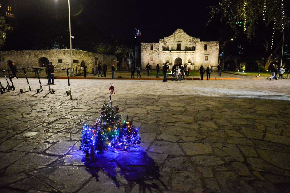 small Christmas tree's are lit as a protest against moving the city's official Christmas tree from Alamo Plaza to Travis Park prior to the 2017 lighting of the tree.