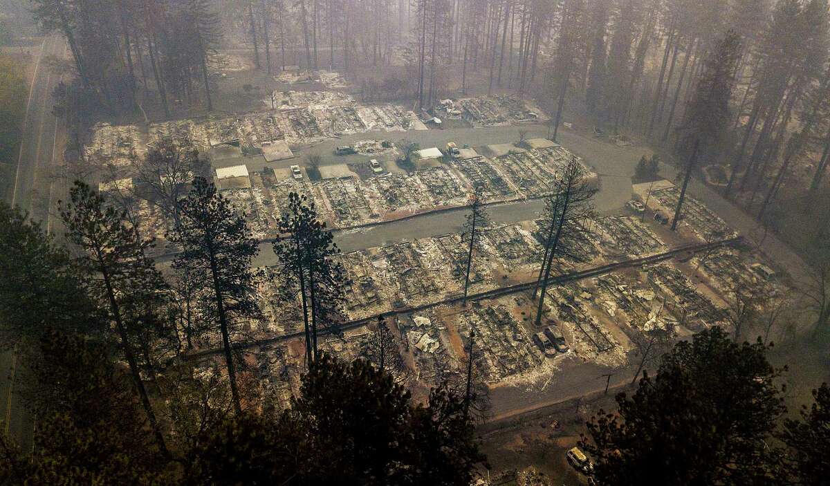 FILE - In this Nov. 15, 2018, file photo, residences leveled by the wildfire line a neighborhood in Paradise, Calif. The massive wildfire that killed dozens of people and destroyed thousands of homes has been fully contained after burning for more than two weeks, authorities said Sunday, Nov. 25. (AP Photo/Noah Berger, File)