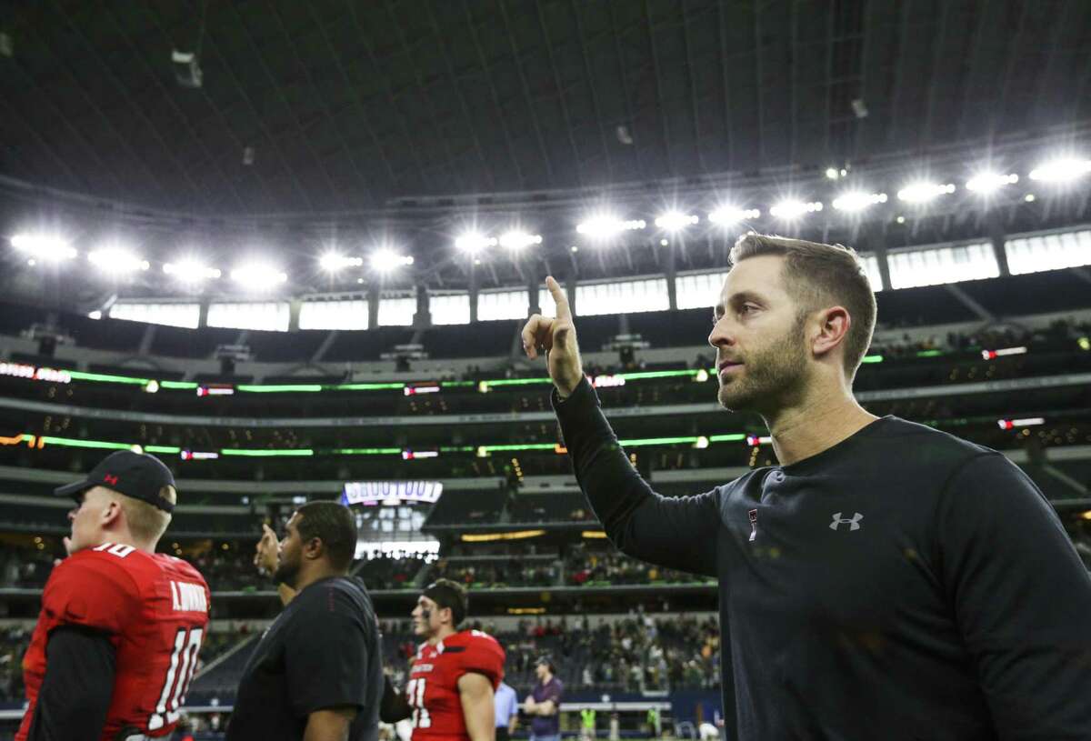 Texas Tech Red Raiders head coach Kliff Kingsbury holds up the Red Raiders hand following Texas Tech's 35-24 loss to Baylor on Saturday, Nov. 24, 2018 at AT&T Stadium in Arlington, Texas. Kingsbury has been fired at Texas Tech after the former record-setting Red Raiders quarterback had a losing overall record in his six seasons as their head coach. Athletic director Kirby Hocutt announced the move in a news release Sunday, Nov. 25, 2018. (Ryan Michalesko/The Dallas Morning News via AP)