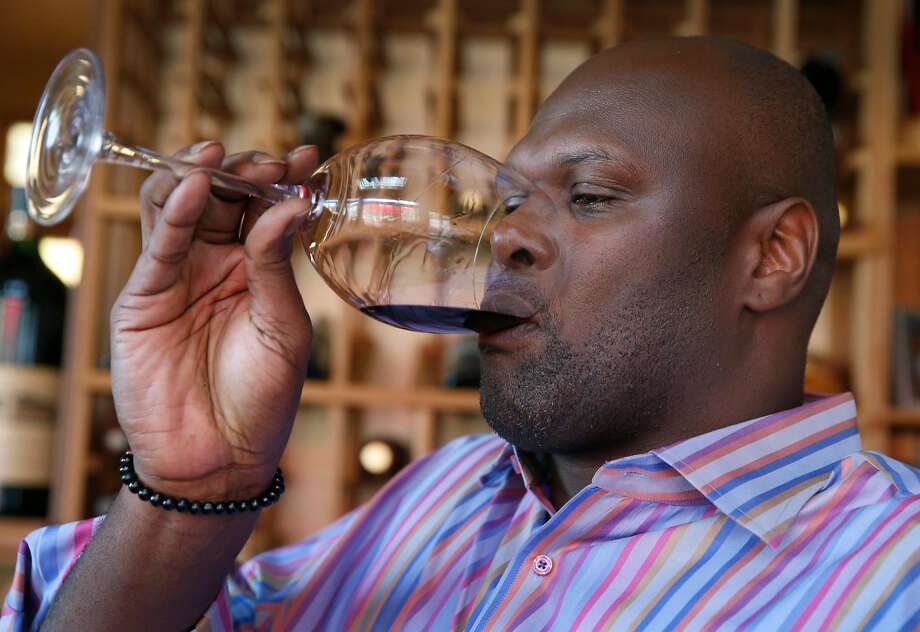 Former Golden State Warriors basketball player Adonal Foyle samples one of the wines from his large collection at his home in Orinda, Calif. on Wednesday, Nov. 14, 2018. Photo: Paul Chinn / The Chronicle