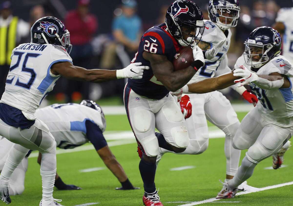 Texans running back Lamar Miller splits a pair of defenders en route to a 97-yard touchdown, which tied the longest of his career when he was with the Dolphins.
