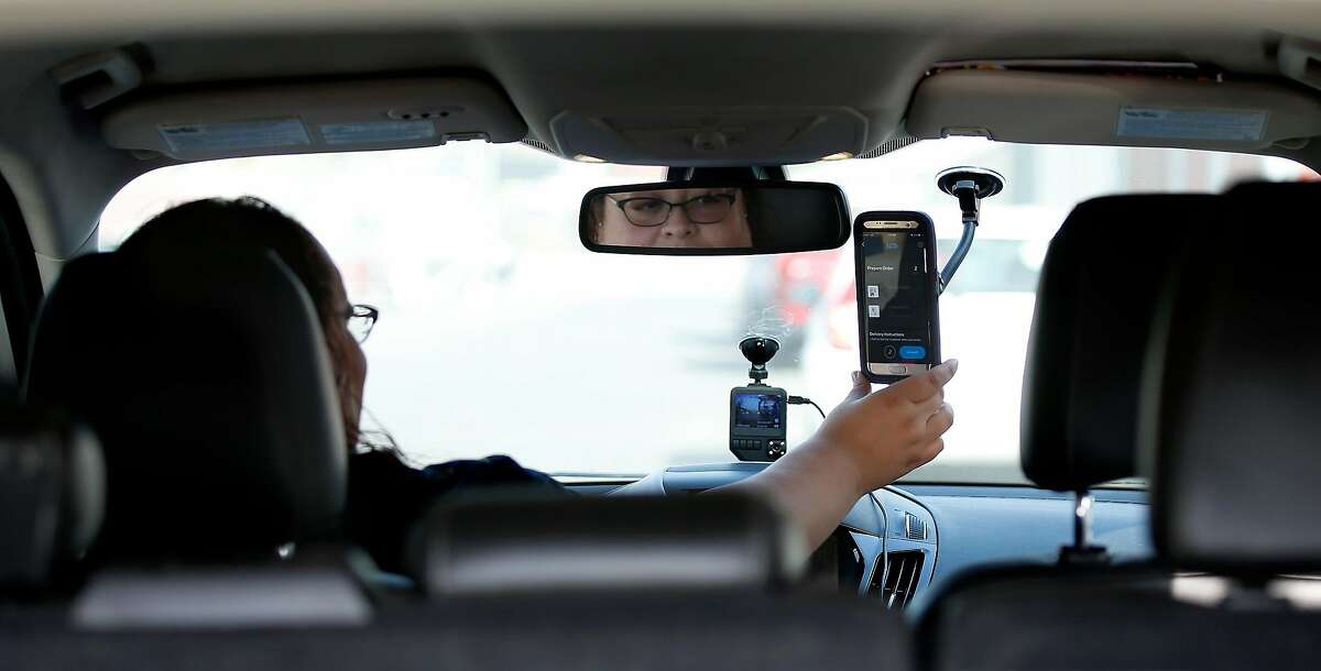 Driver Lilianna Carrasco, receives delivery order on app ease via phone as she gets ready to make a delivery at Caliva in San Jose, Calif., on Nov. 20, 2018. Uber, Lyft drivers are fleeing to become marijuana-delivery drivers � the new in-demand job in the on-demand economy. Caliva employs more than a hundred drivers. (Josie Lepe/Special to the Chronicle)