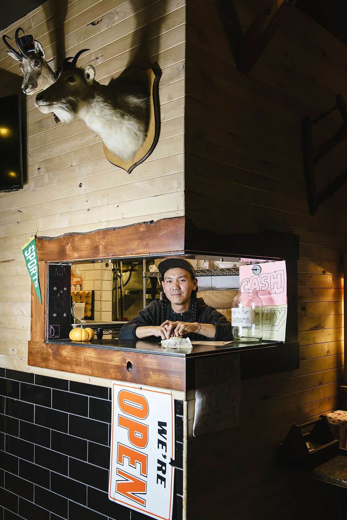 Chef Mike Yoon looks out of the delivery window of his pop-up diner Lovely's, serving Americana food, inside The Lodge bar in Oakland, California, on Wednesday, November 21, 2018.