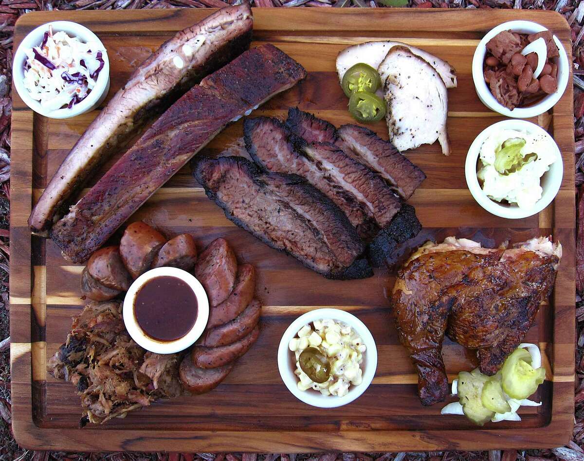 Barbecue and sides from the Mesquite Shack BBQ trailer in San Antonio. Clockwise from top left: cole slaw, pork spare ribs, brisket, turkey, beans, potato salad, chicken, creamed corn, sausage, barbecue sauce and pulled pork.
