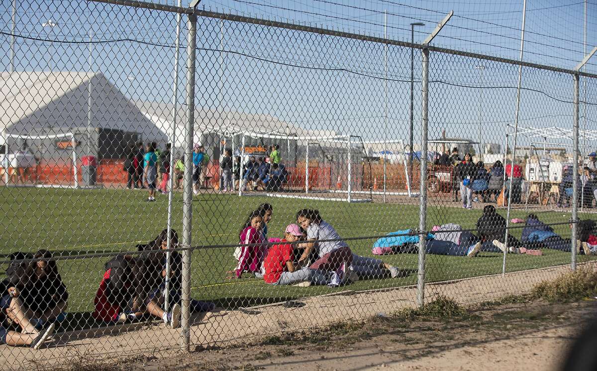 CORRECTS TO CLARIFY TEENS WERE NOT LOOKING AT PROTESTERS AS THERE WERE NOT PROTESTS THAT DAY - In this Nov. 25, 2018 photo provided by Ivan Pierre Aguirre, migrant teens held inside the Tornillo detention camp sit inside the facility in Tornillo, Texas. The Trump administration announced in June 2018 that it would open the temporary shelter for up to 360 migrant children in this isolated corner of the Texas desert. Less than six months later, the facility has expanded into a detention camp holding thousands of teenagers - and it shows every sign of becoming more permanent. (Ivan Pierre Aguirre via AP)