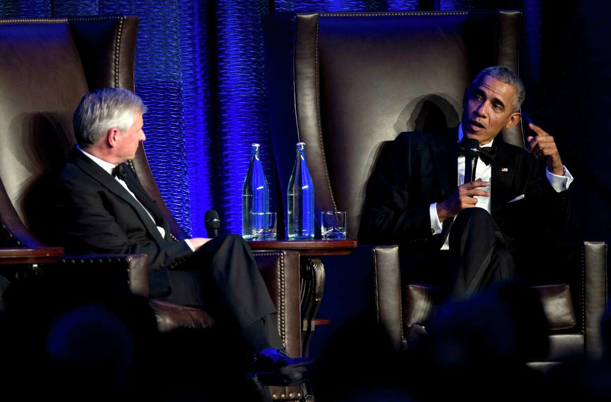 Former President Barack Obama speaks with Jon Meacham as he takes the stage during the 25th anniversary gala celebration for Rice University’s Baker Institute for Public Policy on Tuesday, Nov. 27, 2018, in Houston.