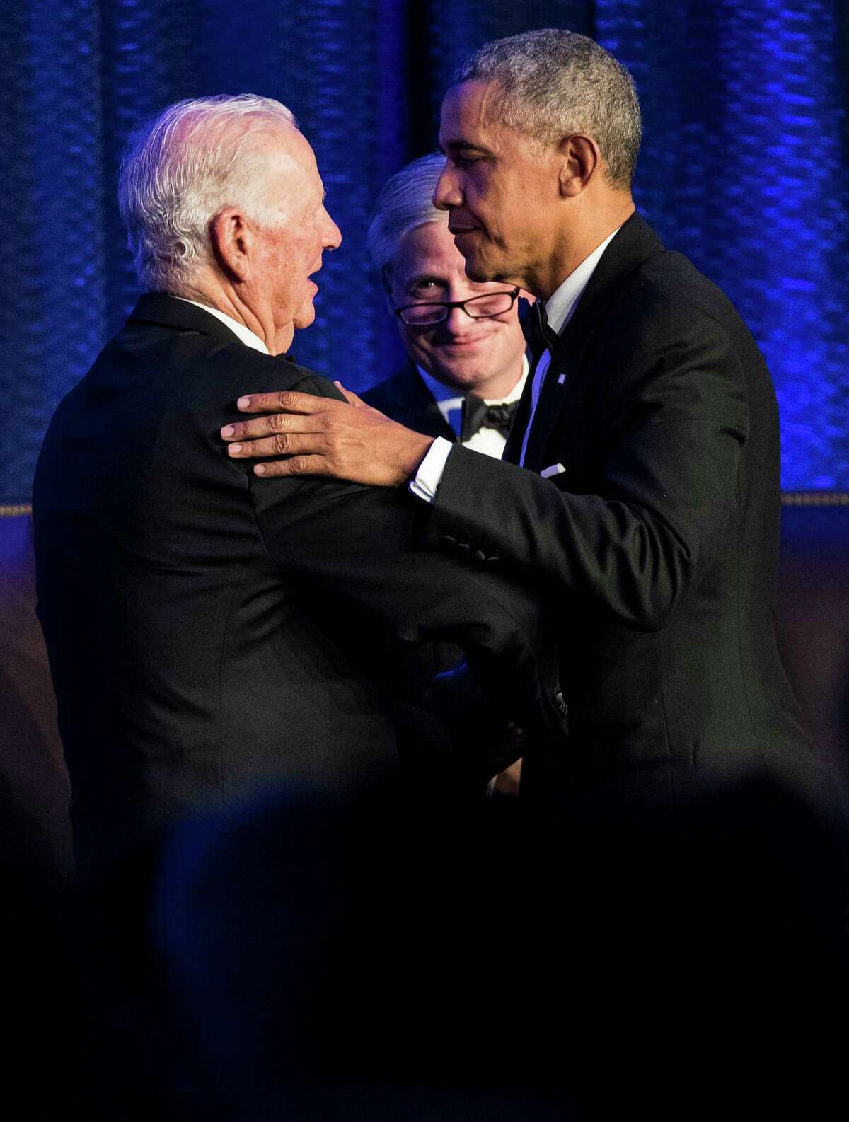 Former Secretary of State James A. Baker III, left, historian Jon Meacham, center, and former President Barack Obama stand and embrace following their conversation during the 25th anniversary gala celebration for Rice University’s Baker Institute for Public Policy on Tuesday, Nov. 27, 2018, in Houston.