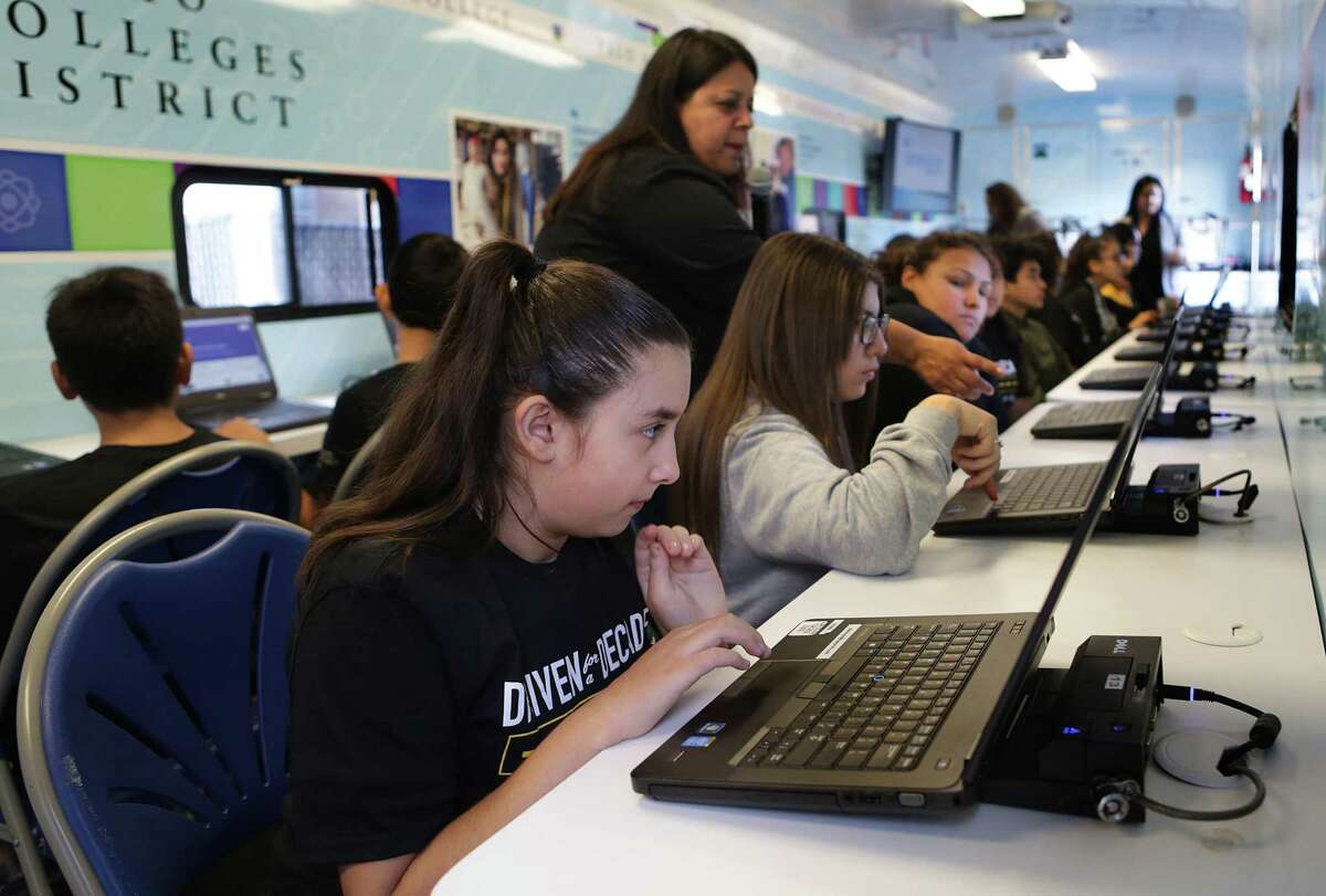 Melina Castro, left, and other eigth graders at Brentwood Middle School tour through Alamo Colleges District's current Mobile GO Center at Brentwood Middle School in the Edgewood ISD, on Wednesday, Nov. 28, 2018. The GO Center travels to schools and organizations to help students and parents apply for colleges and fiancial aid.