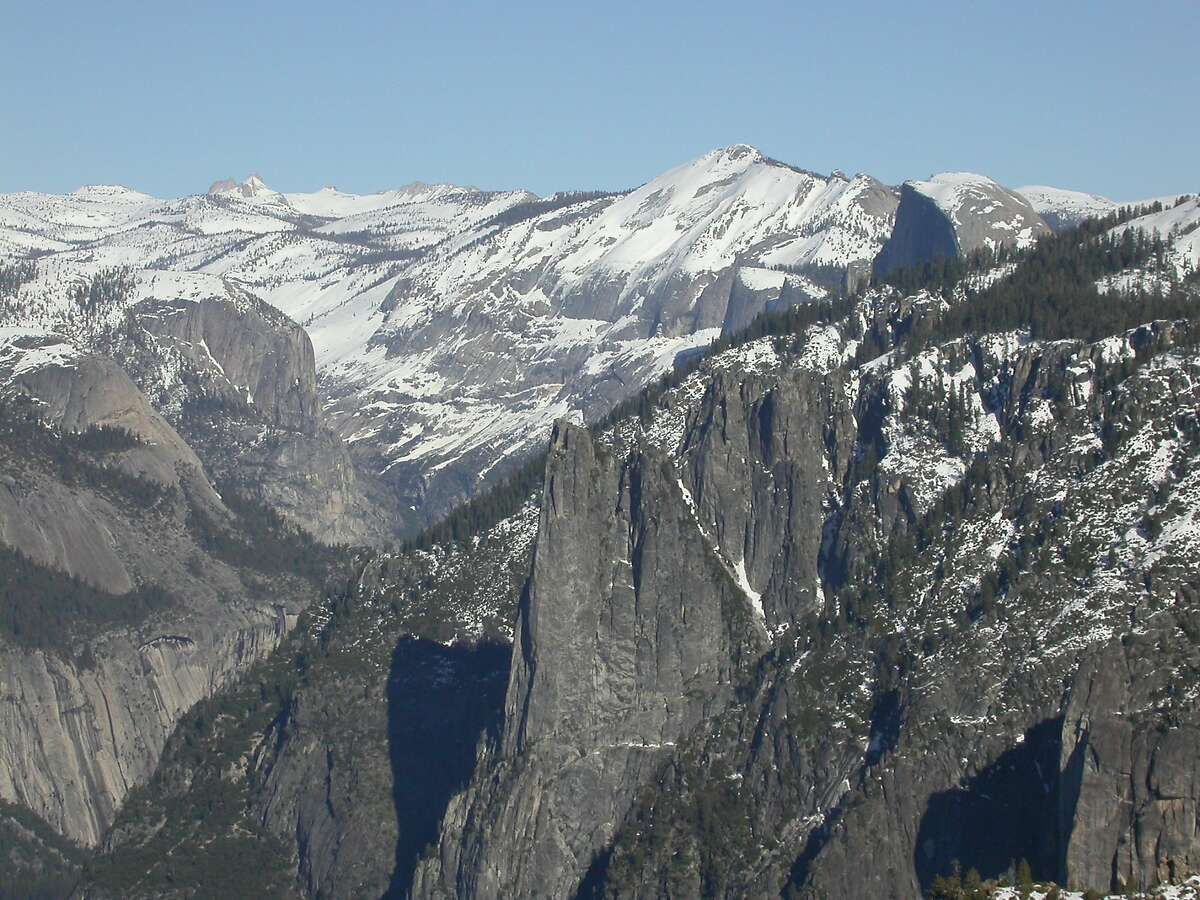 From southern rim of Yosemite Valley, looking east at Cathedral Rocks and beyond to Half Dome, Clouds Rest and miles of Yosemite backcountry after snow fell across the high country