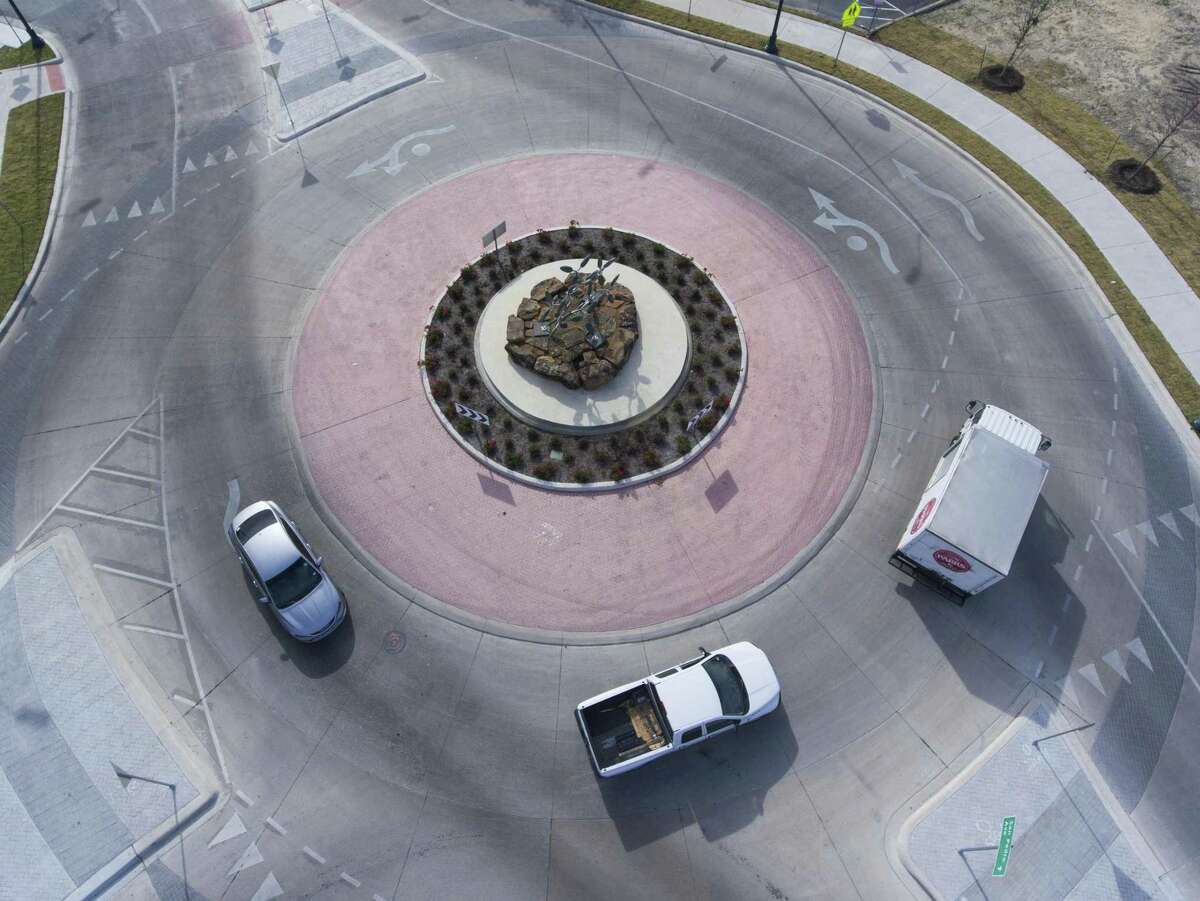 Traffic moves Wednesday, Nov. 28, 2018 through the city's new and only two-lane roundabout in downtown San Antonio near the Central Library.
