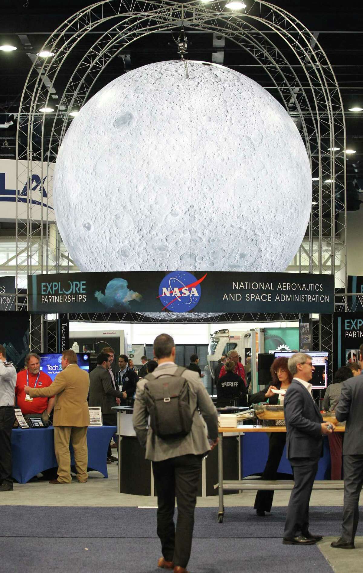 A large moon over NASA's display is on the show floor at the annual SpaceCom (Space Commerce Conference and Exposition) Tuesday, Nov. 27, 2018, in Houston.