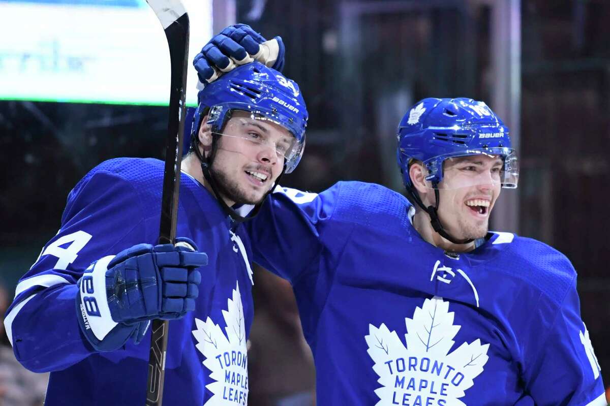 Toronto Maple Leafs center Auston Matthews (34) celebrates his goal against the San Jose Sharks with teammate and left wing Andreas Johnsson (18) during the third period of an NHL hockey game, Wednesday, Nov. 28, 2018, in Toronto. (Nathan Denette/The Canadian Press via AP)