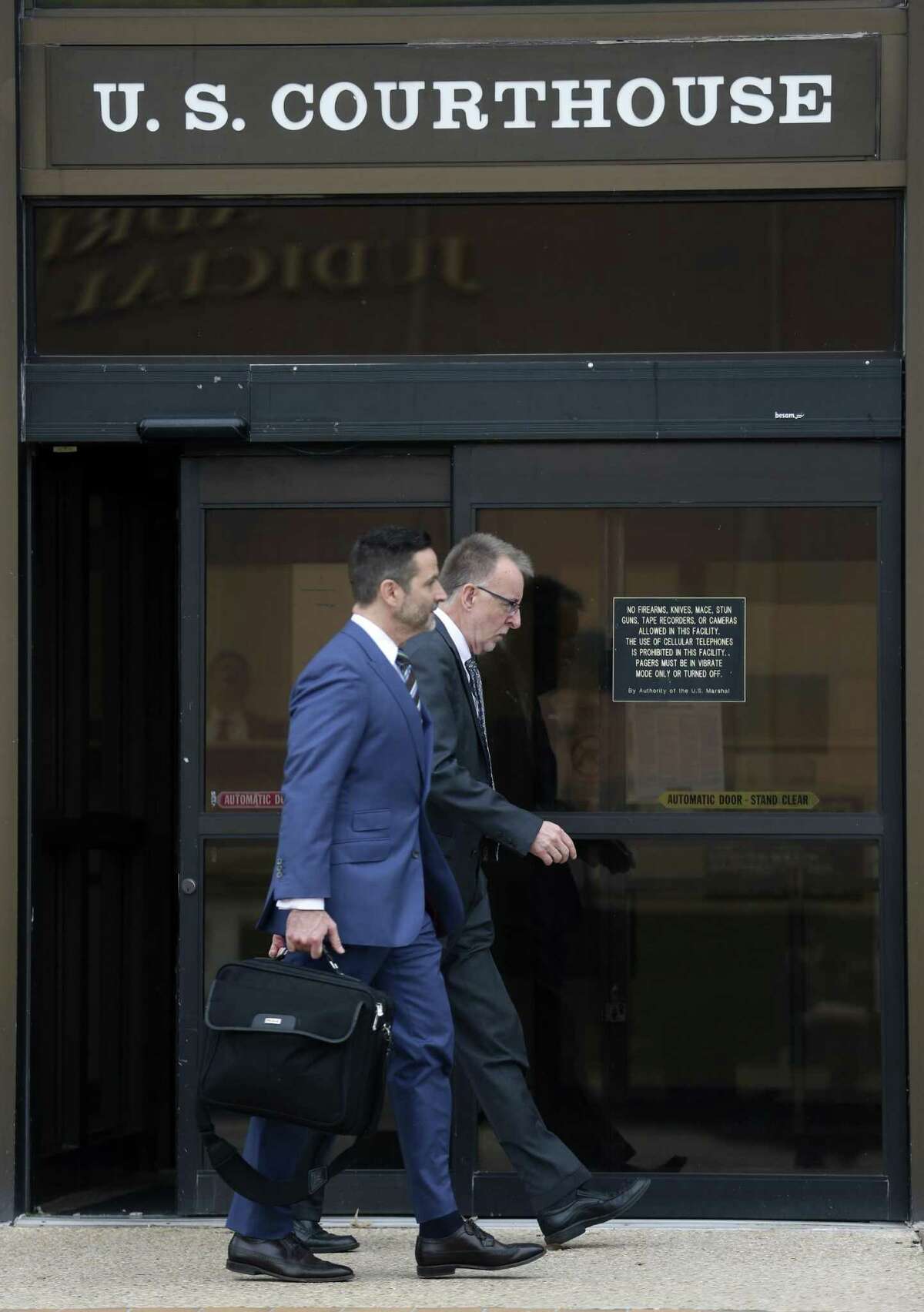 Daniel Lee Burke, right, leaves the John H. Wood Federal Courthouse on Thursday with his attorney Jeffrey Ansley after being sentenced to five years of probation for wire fraud.
