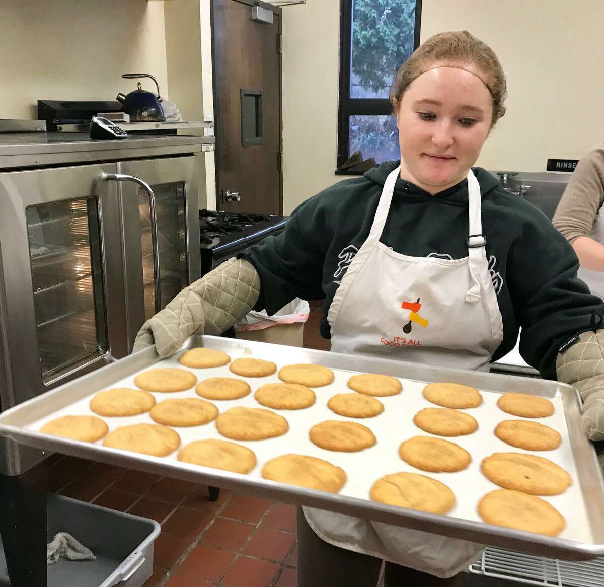 Right, the scent of cinnamon fills the air as Melissa Weaver, a senior at Sacred Heart University, removes a tray of snickerdoodles from the oven.