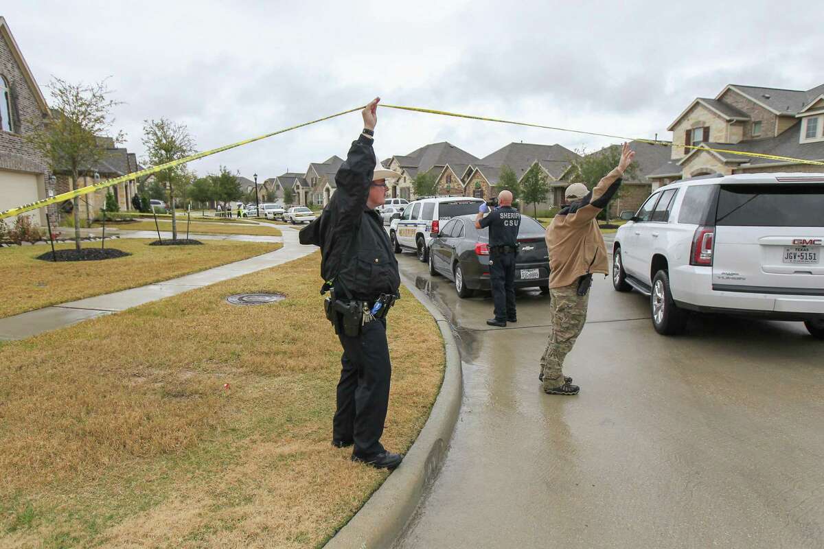 Law officials allow a vehicle to enter the cul-da-sac of a scene where a homeowner was killed during what is believed to have been a home invasion in the 10800 block of Gates Randall Court Thursday, Nov. 29, 2018, in Cypress.