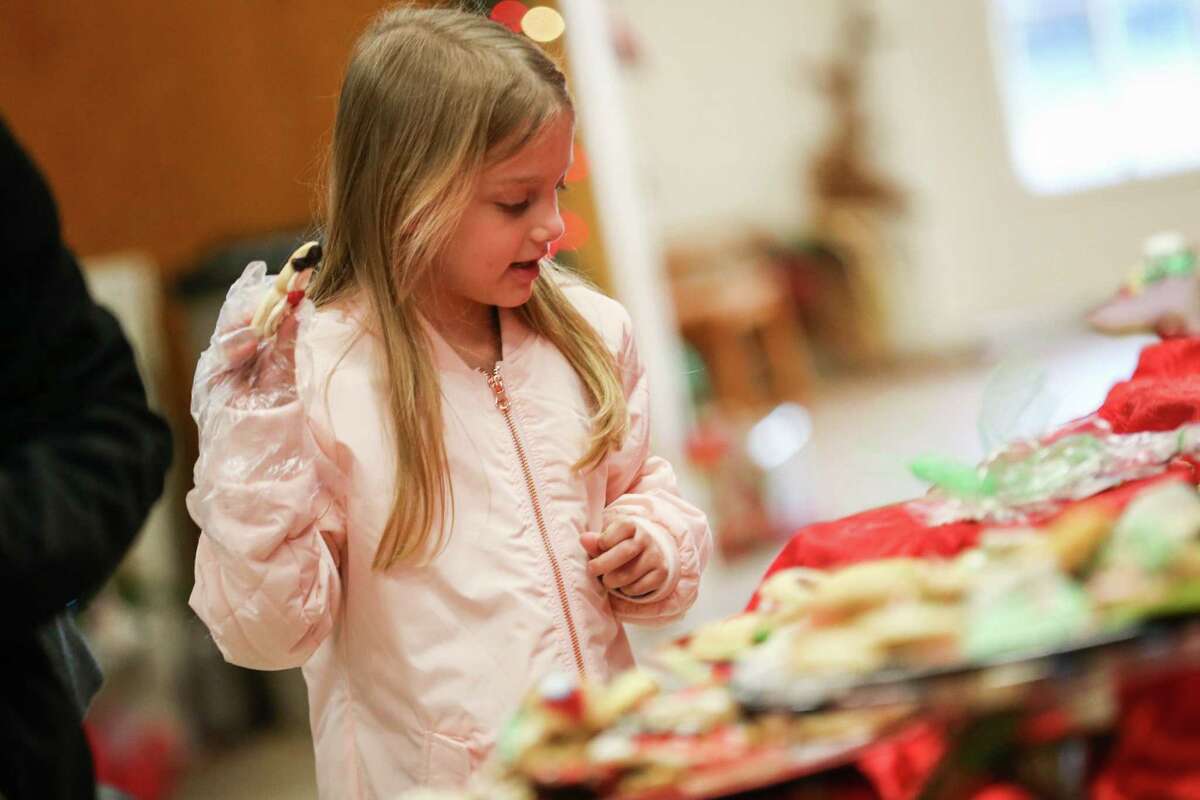 Mariah Probasco, 6, claims a cookie while browsing during the 26th annual Cookie Walk on Saturday, Dec. 9, 2017, in downtown Montgomery. Proceeds from the Cookie Walk go to preserving the historical markers and homes in Montgomery.